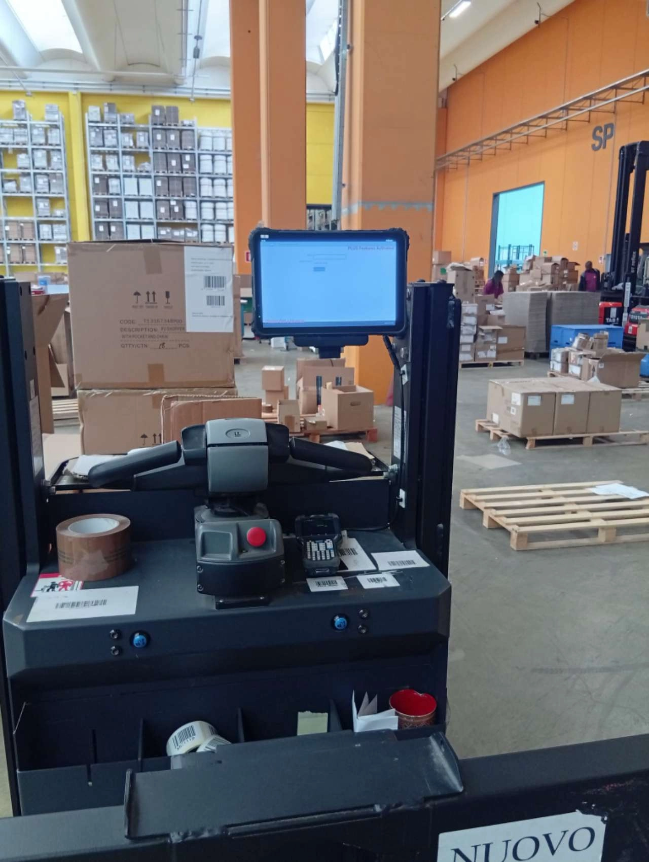 MDT1065 10-inch Rugged tablet mounted on warehouse order picker operator console displaying WMS pick instructions with barcode scanner
